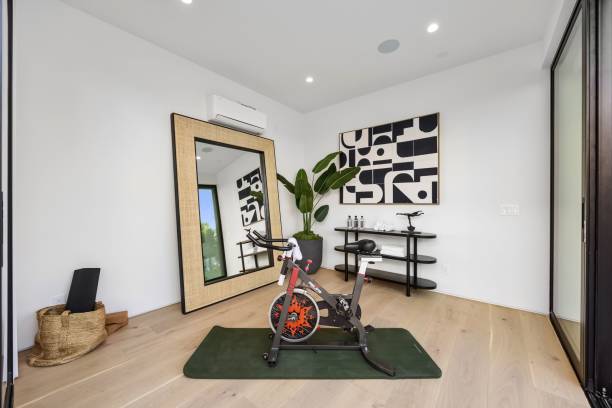 istock Modern home gym with exercise bike and abstract art. 2179171085
