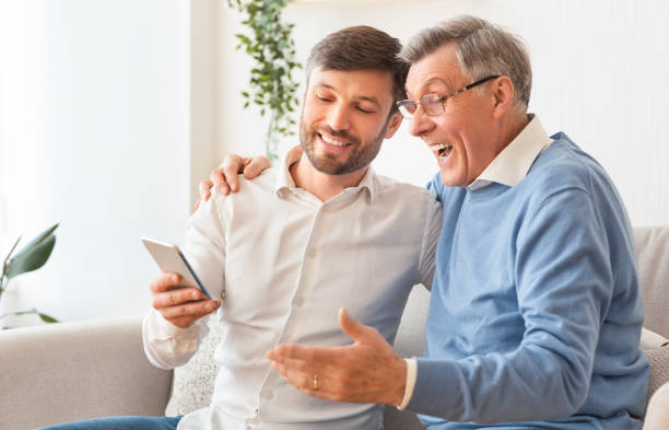 istock Middle-Aged Son Showing Elderly Father How To Use Smartphone Indoor 2179171272