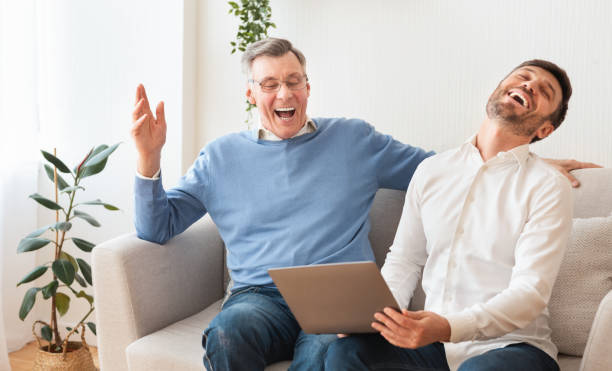 istock Adult Son And Elderly Father Using Laptop Sitting At Home 2179171300