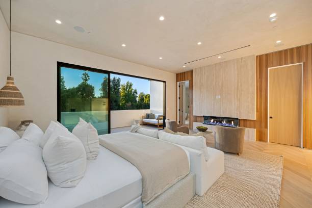 istock Modern bedroom with fireplace and outdoor view 2179172229