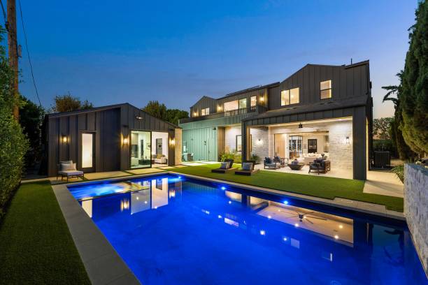 istock Modern luxury home with illuminated pool at dusk. 2179172277