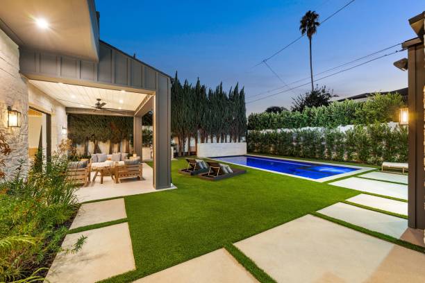 istock Modern backyard with pool and patio at dusk. 2179172693