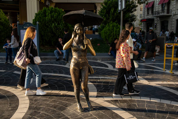Hong Kong, China - April 26, 2017: Bronze Statue of Girl Sitting on Bench in Front of Art Gallery at Central Spring Day.