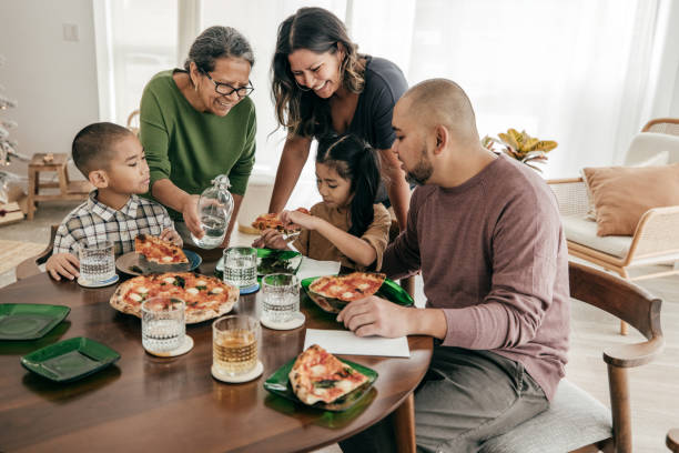 istock Multi-ethnic family having pizza for lunch 2179182654