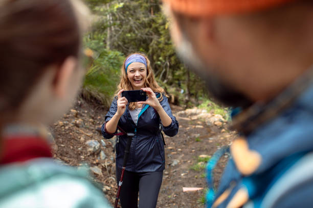 istock Young family taking a picture while out hiking in a forest 2179183575