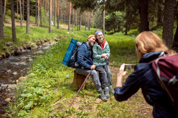 istock Young family taking a picture while out hiking in a forest 2179183908