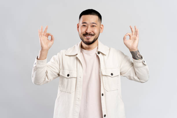 istock Happy man showing ok sign with both hands is smiling at camera 2179185950