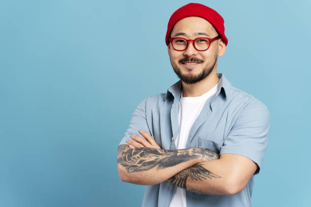 istock Confident male designer smiling with folded arms on blue background 2179188068