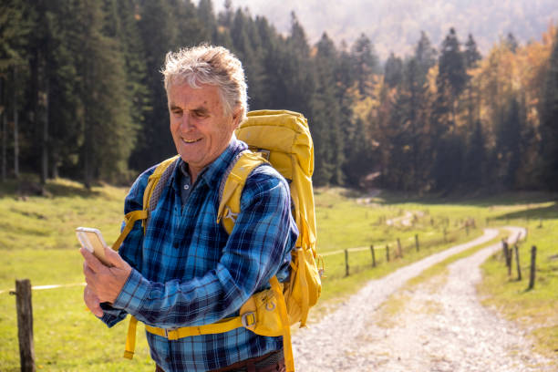 istock Senior man hiking and using smart phone 2179190757