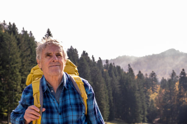 istock Senior man hiking in the forest 2179191136