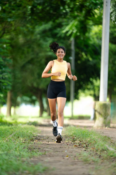 istock Athlete woman running in public park 2179191728