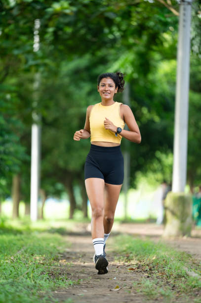 istock Woman running in the park 2179191752