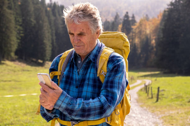 istock Senior man hiking and using smart phone 2179191769