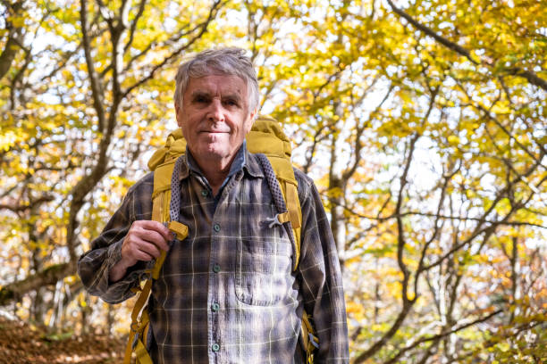 istock Senior man hiking in the autumn forest 2179193477