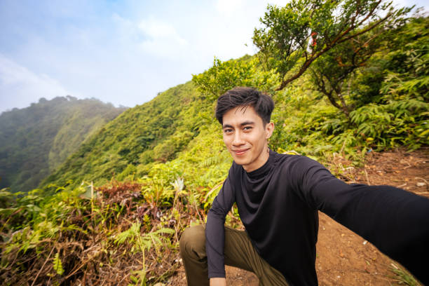 istock Mountain Climber Facing Camera with Breathtaking View Behind. Majestic Mountain Scenery with Endless Horizon. 2179195956