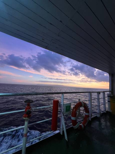 istock Ship deck at sunset with a vibrant sky and calm ocean, featuring safety equipment. Bali, Indonesia 2179198974