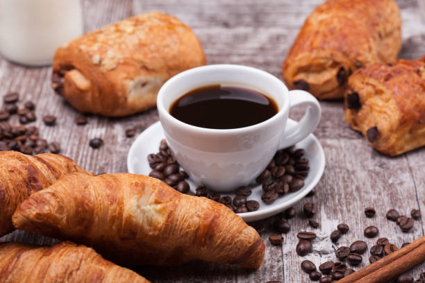 istock Cup of Coffee with Pastry on rustic wood table background 2179199854