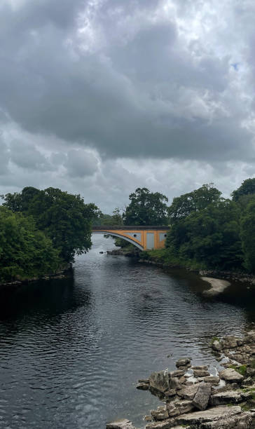 istock Cloudy landscape of river and bridge in UK 2179205113