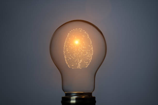 istock Digital security concept with person identity fingerprint in glowing light bulb 2179208234