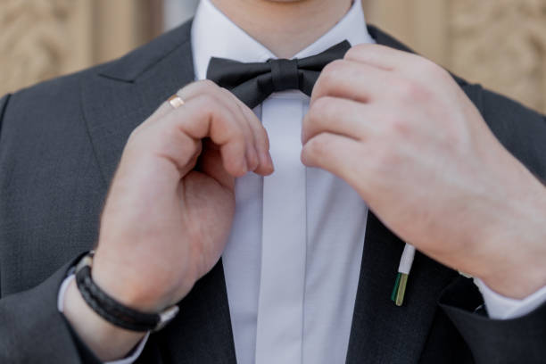 istock a man wears a bow tie in a black suit 2179213094