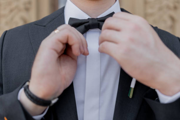 istock a man wears a bow tie in a black suit 2179214182