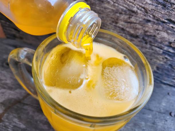 istock Pourinkg orange soft drink and ice cubes 2179214533