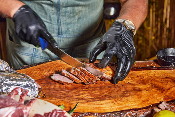 istock Chef Slicing Meat on a Wooden Board 2179217585