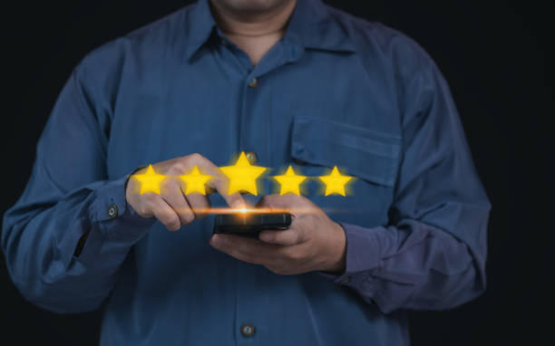 istock Businessman Selecting Five Star Satisfaction Rate on Virtual Screen on Mobile App for Positive Feedback : Modern Success in Digital Communication or Complacent Achieving Excellence in User Experience 2179218197