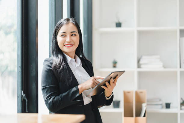 istock confident businesswoman using tablet in modern office setting, showcasing professionalism and engagement. Her smile reflects positivity and determination. 2179219481