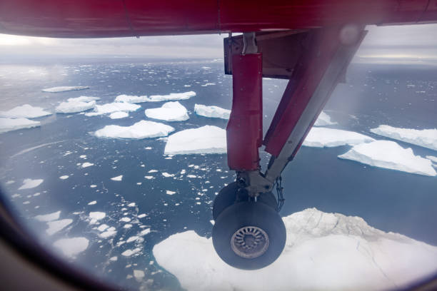 Ilulissat, Jakobshavn, Greenland, Denmark - August 22th 2024:  Landing wheel of an approaching Dash 8 from Greenland Air over the famous ice fjord outside Ilulissat or Jacobshavn in western Greenland