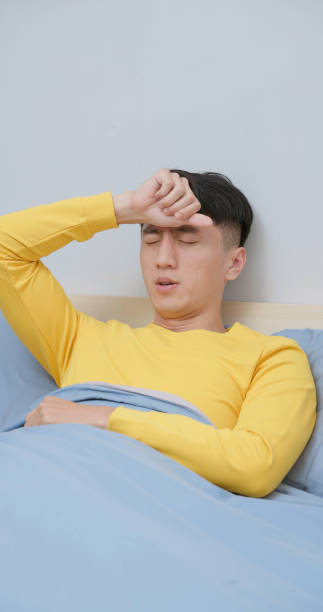 istock asian young male fever home 2179220157