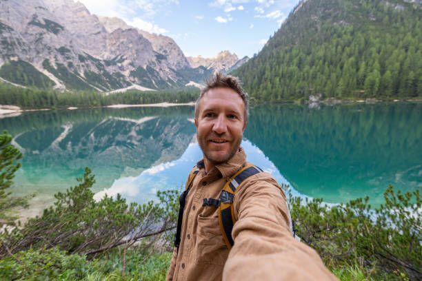 istock Hiker Taking a Selfie by a Pristine Mountain Lake 2179224416