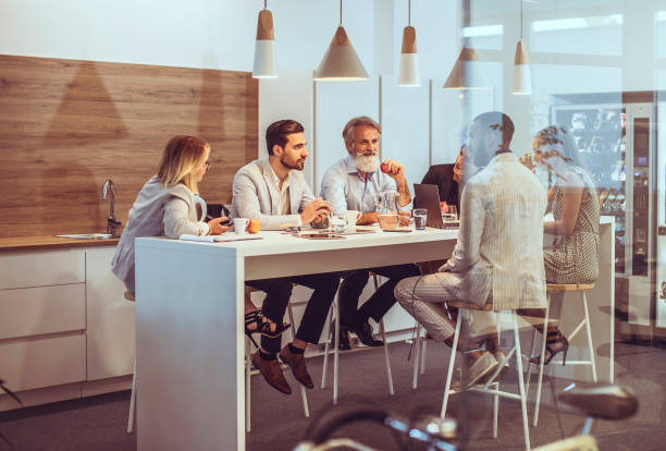 istock Diverse Executives Engage in Strategic Discussion at Office Cafeteria 2179227262