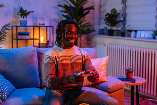 istock Young Man Playing Video Games At Home At Night 2179229862