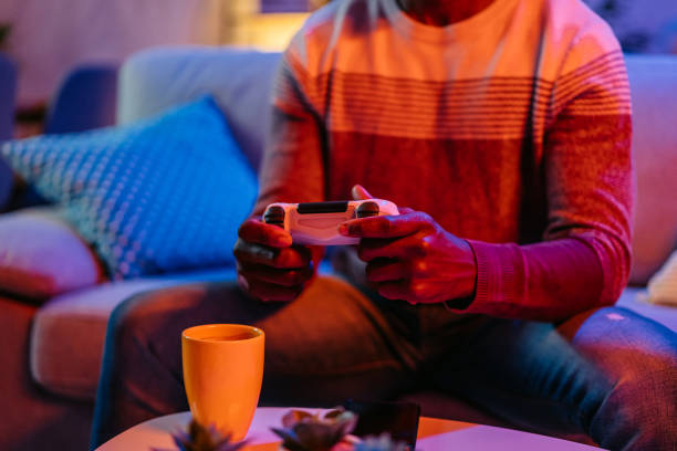 Young Man Playing Video Games At Home At Night