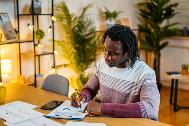 istock Young Man Checking His Finances At Home At Night 2179233362