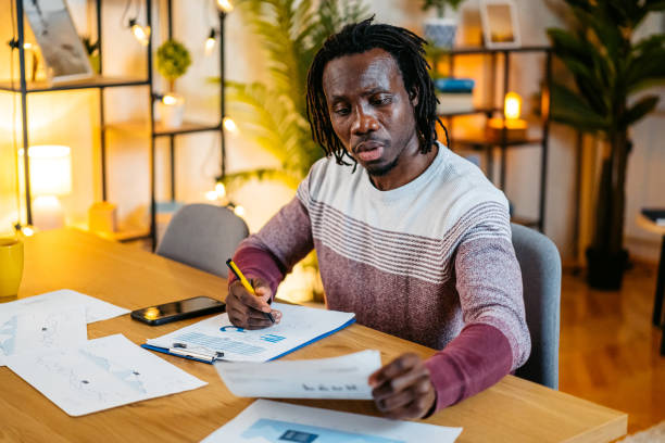 istock Young Man Checking His Finances At Home At Night 2179233770