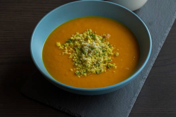 istock Carrot Soup with Coconut in a Blue Bowl - Close-Up 2179236464