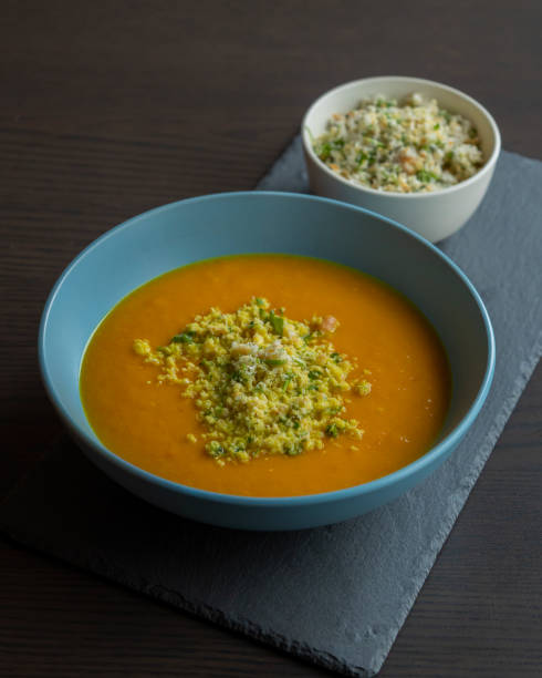 istock Carrot Soup with Coconut in a Blue Bowl - Close-Up 2179236521