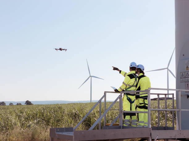 istock The engineering team is surveying the area to install a large wind turbine for converting wind energy into electricity 2179254749