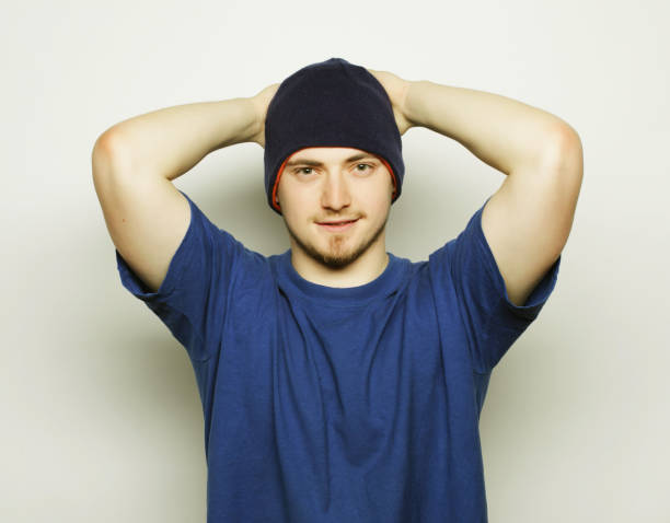 Life style, sport and people concept - young handsome man in blue t-shirt and blue hat.