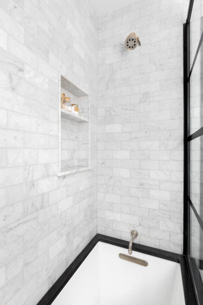 istock A shower with white marble subway tiles. 2179261447
