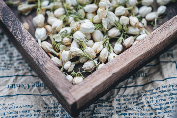 Dried jasmine tea in wooden box macrophotography
