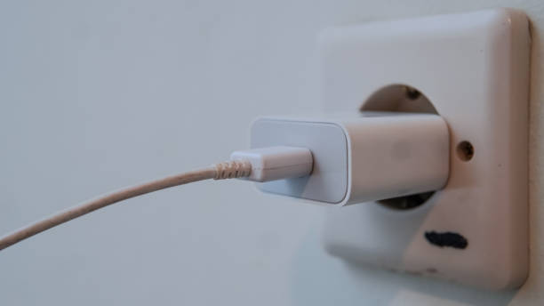 istock An adapter and charger cable to charge the cellphone are installed in a wall socket 2179292690