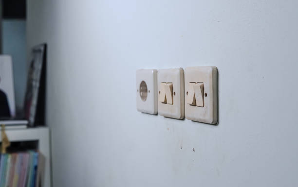 istock Three Light Switches Adorn the Wall 2179294080