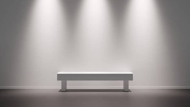 Minimalist interior of an art gallery with a white bench and a bright blank wall