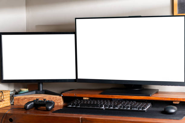istock Dual Monitors and Gaming Setup on Wooden Desk 2179323136