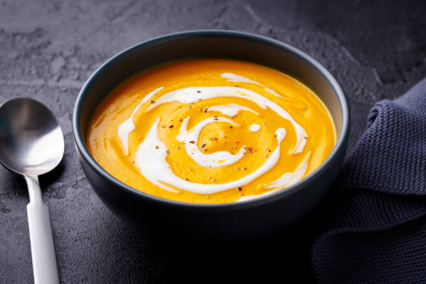 istock Pumpkin soup in black bowl. Dark grey background. Close up. 2179326072