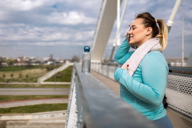 istock Overweight woman hydrating after exercising 2179327040