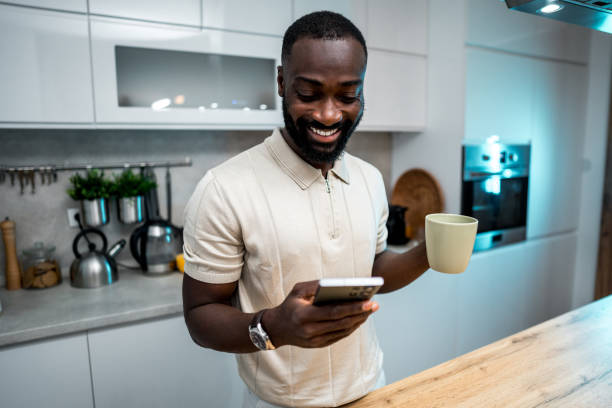 istock Man drinking coffee and reading news on phone 2179331880